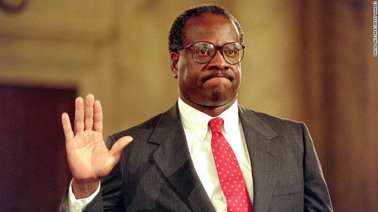 US Supreme Court nominee Clarence Thomas raises his right hand as he is sworn in during confirmation hearings in Washington on September 10, 1991.