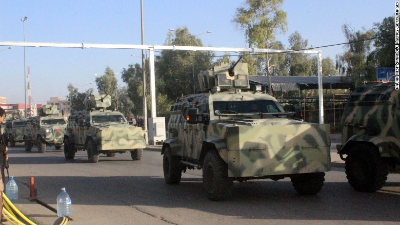 Security forces arrive with armoured vehicles after ISIS attacks in Kirkuk, Iraq, October 21, 2016.