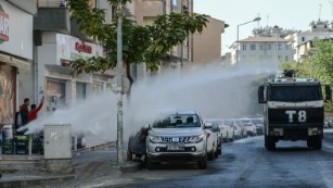 Turkish anti-riot police use water a cannon to disperse protesters on October 26, during a demonstration against the detention of the Kurdish-majority city&#39;s co-mayors in Diyarbakir.