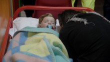 A child sleeps in a secured area of Visso after earthquakes rocked central Italy.