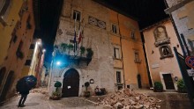People wander around the small town of Visso, in central Italy, in the early hours of Thursday after the quake destroyed part of their neighborhood. 