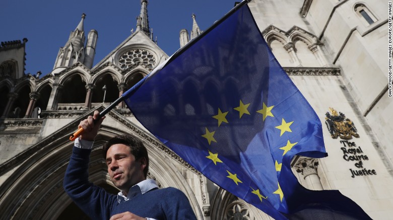 Phil Jones, &#39;People&#39;s Challenge&#39; member waves an EU flag outside the Royal Courts of Justice.