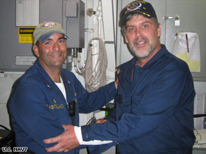 Capt. Richard Phillips, right, stands with U.S. Navy Cmdr. Frank Castellano after Phillips' rescue Sunday.