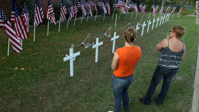 Women look at a temporary memorial in memory of those killed and wounded at Fort Hood, Texas, in 2009. 