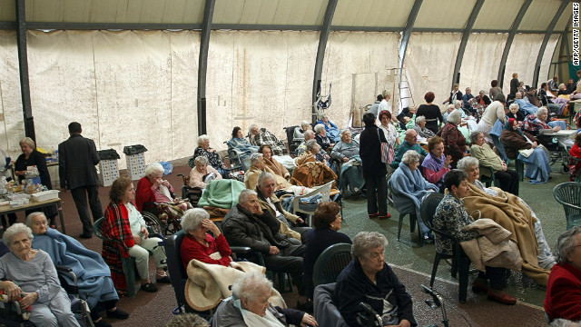 Elderly people rest after being evacuated to a sports center in Finale Emilia after the quake. 