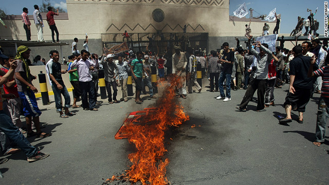 Yemeni protesters gather around fire during a demonstration outside the US embassy in Sanaa over a film mocking Islam on September 13, 2012.