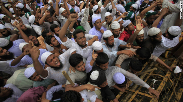 Bangladeshi Muslims attempt to break a police barricade during a protest in Dhaka on Friday.