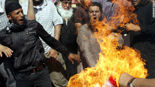 Jordanian protesters burn a U.S. flag near the U.S. Embassy in Amman on Friday.