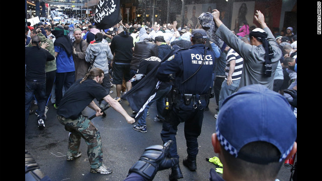 A protester hits a policeman with a pole in Sydney's central business district on Saturday, September 15. Anger over an anti-Islam video, "The Innocence of Muslims," spread to Australia on Saturday, and protesters took to the streets of the country's capital.
