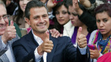 The presidential candidate for Mexico's Institutional Revolutionary Party (PRI), Enrique Peña Nieto, gives his thumbs up showing his ink-stained thumbs, after casting his vote in the presidential elections, in Atlacomulco, state of Mexico, on July 1, 2012.