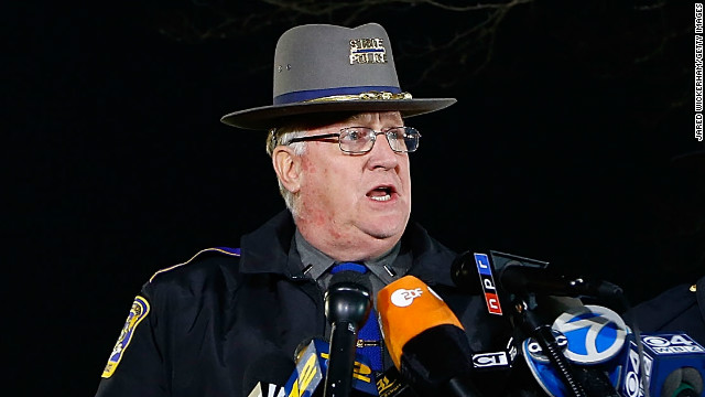 Connecticut State Police spokesman Lt. J. Paul Vance, center, briefs the media on the elementary school shootings during a press conference at Treadwell Memorial Park on December 14 in Newtown.