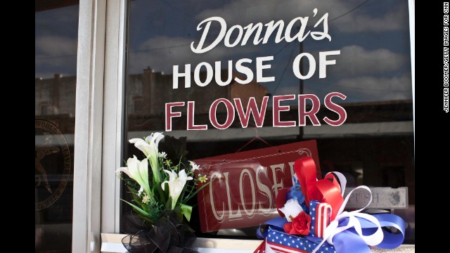Donna's 
House of Flowers is closed, and a note on the door explains the tragic reason: Her husband and brother-in-law, both volunteer firefighters, died in the explosion.