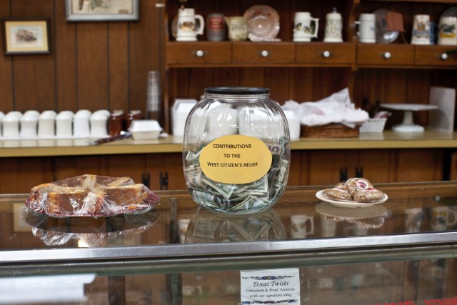 A collection jar fills at The Village Bakery in West, where people look out for their own.