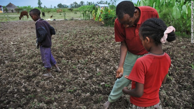 A farmer and his children plant a field with bean seeds and fertilizer in southern Ethiopia in 2008, a year after severe floods in the country destroyed most of the food crop. Ethiopia is the 10th most vulnerable country to climate change impacts, according to a report by Maplecroft.