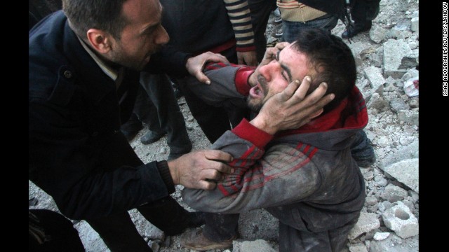 A man reacts after what activists said was an air raid by forces loyal to Syrian President Bashar al-Assad in the al-Marja district of Aleppo on Monday, December 23. The United Nations estimates more than 100,000 people have been killed since the Syrian conflict began in March 2011. Click through to see the most compelling images taken during the conflict, which is now a civil war: