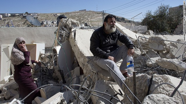 A Palestinian man from the Beshr family sits on the debris of his house after it was demolished by Israeli authorities who said it was built without municipal permission on February 5, 2014 in the Arab east Jerusalem neighborhood of Jabel Mukaber.