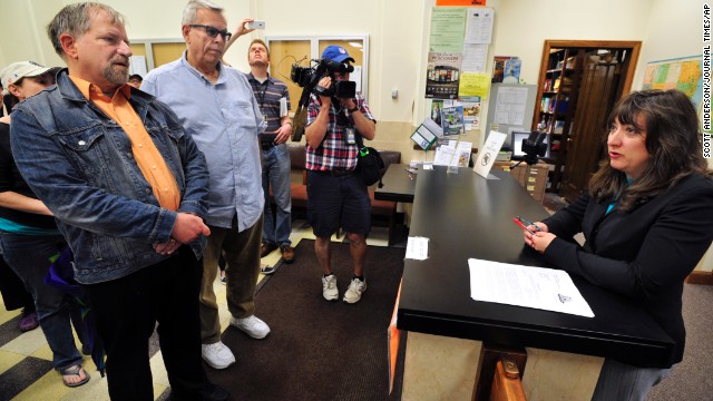 The Rev. Tony Larsen and his partner, Craig Matheus, are refused a marriage license by Racine County Clerk Wendy Christensen, right, in the clerk's office in Racine, Wisconsin, on Friday, June 13. The county does not grant marriage licenses to same-sex couples despite a judge's ruling that the state ban on gay marriage is unconstitutional. 