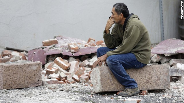 Ron Peralez sits on rubble and looks at damaged buildings on Monday, August 25, in Napa, California. The San Francisco Bay Area's strongest earthquake in 25 years struck the heart of California's wine country on August 24.