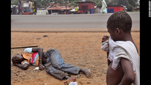 A child stops to look at a man who is suspected of suffering from the Ebola virus on a main street in Monrovia, Liberia, on Friday, September 12. Health officials say the current Ebola outbreak in West Africa is the deadliest ever. More than 4,700 cases have been reported since December, with more than 2,400 of them ending in fatalities, according to the World Health Organization. 