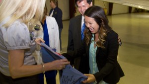 After being greeted by her father, Peter, Nina Pham is presented with scrubs signed with well wishes by her colleagues at Texas Health Presbyterian Hospital Dallas. 