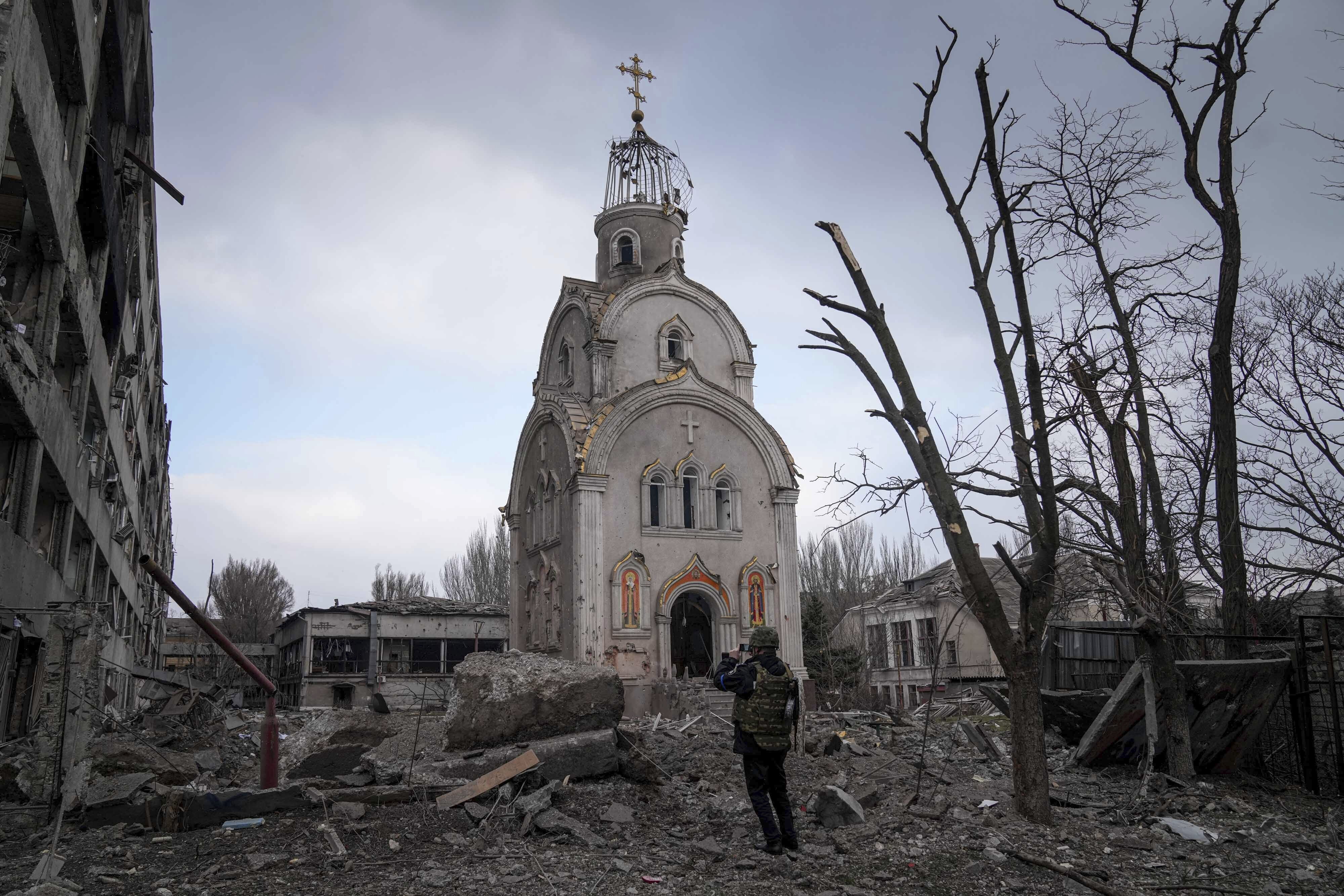 The golden turret of a church is burnt out among rubble