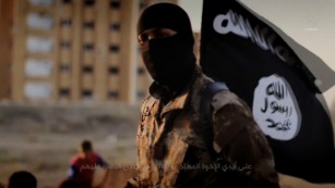 An English-speaking ISIS fighter orchestrates the mass execution of a group of men in an ISIS recruitment video called &quot;Flames of War.&quot;