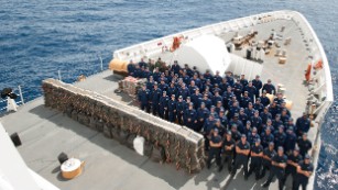 The Coast Guard Cutter Stratton crew with cocaine bales seized.