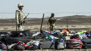 Egyptian army soldiers stand guard next to the luggage and belongings of passengers of the A321 Russian airliner piled up at the site of the crash in Wadi el-Zolmat, a mountainous area in Egypt&#39;s Sinai Peninsula on Sunday, November 1. International investigators began probing why a Russian airliner carrying 224 people crashed in Egypt&#39;s Sinai Peninsula, killing everyone on board, as rescue workers widened their search for missing victims. 