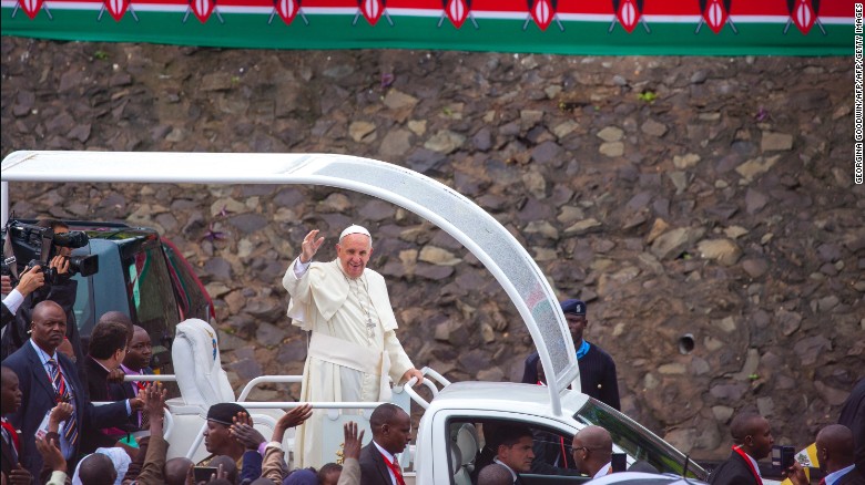 Pope Francis waves to a crowd at the University of Nairobi, Kenya, as he arrives to deliver a giant open-air mass on November 26, 2015.
