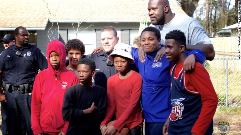 Shaquille O'Neal poses with a group of neighborhood kids in Gainesville, Florida.