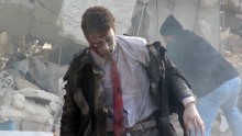 A man emerges from the wreckage of a courthouse in rebel-held Idlib, Syria after it was hit by airstrikes in December 2015.