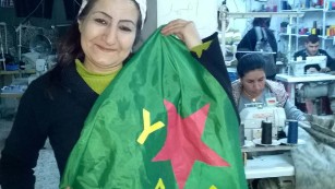 The YPJ flag belongs to the women&#39;s defence units and was &#39;modelled&#39; by a worker in a sewing collective.