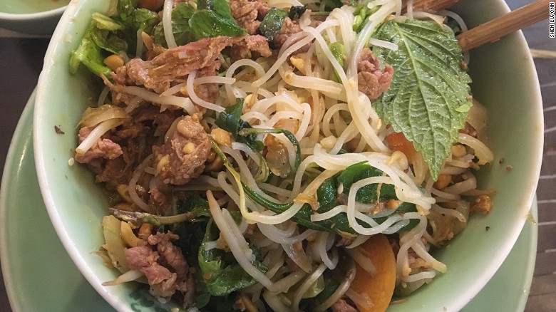 In this broth-free bowl of vermicelli noodles, tender slices of beef mingle with crunchy peanuts, bean sprouts, fresh herbs, crisp dried shallots, a splash of fish sauce and fiery chili pepper.