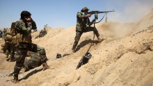 Iraqi government forces engage with ISIS forces near the village of al-Sejar, northeast of Falluja, on May 26.