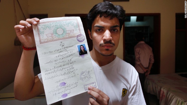 Hassan Khan, husband of Zeenat Rafiq, shows his marriage certificate to media.