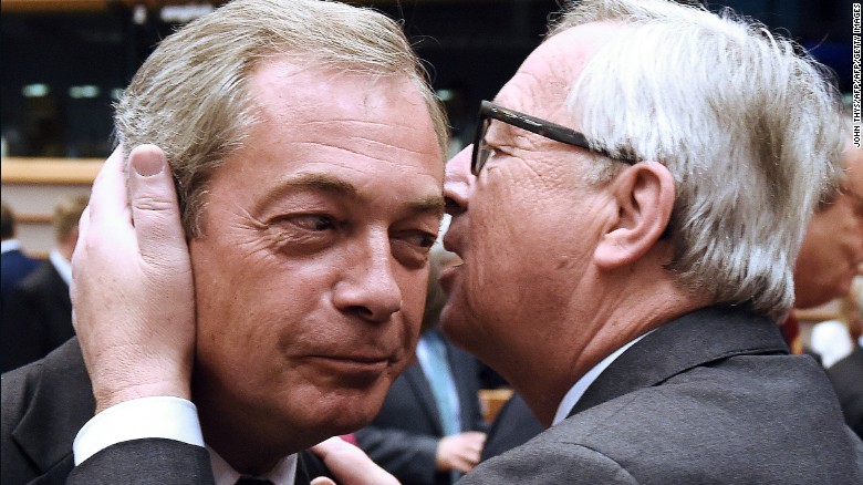 European  Commission President Jean-Claude Juncker speaks in the ear of UK Independence Party leader Nigel Farage Tuesday.