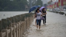 People cross a flooded bridge in Wuhan on July 2. 