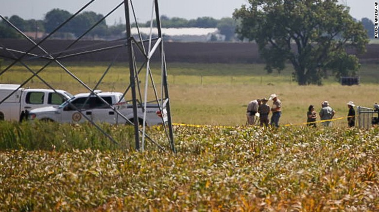 Investigators surround the scene in a field near Lockhart, Texas where a hot air balloon carrying at least 16 people collided with power lines Saturday, July 30, 2016,  causing what authorities described as a &quot;significant loss of life.&quot;  (Ralph Barrera/Austin American-Statesman via AP)