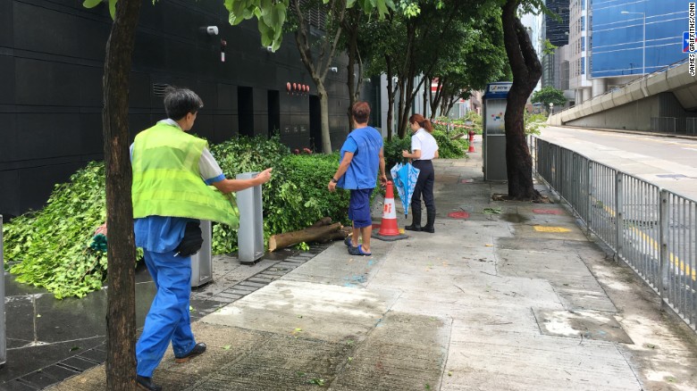 Workers remove fallen tree branches from a street in eastern Hong Kong. 