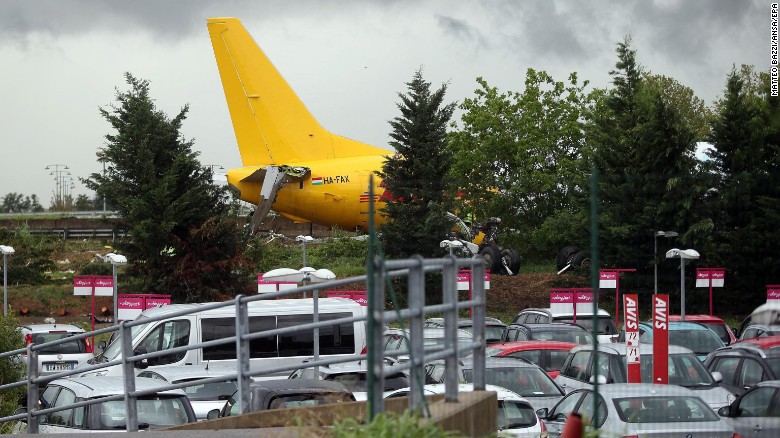 The DHL courier company&#39;s Boeing 737-400 cargo aircraft rests on a road after it came off the runway during landing at airport of Bergamo Orio al Serio, Italy, on Friday, August 5.