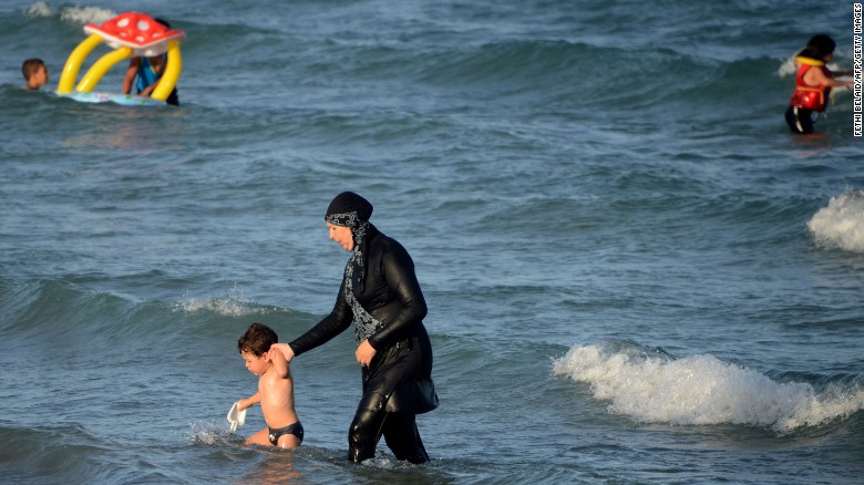 A woman wears a burkini, on a beach near Tunis, Tunisia. 