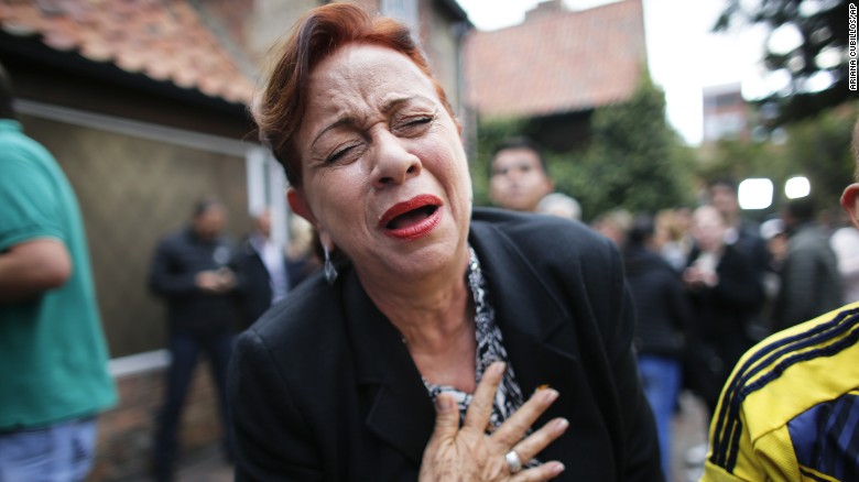 An opponent to the peace deal signed celebrates after she listened to the results of the referendum. 