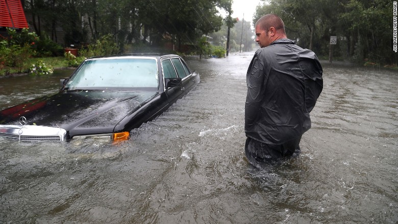 Nick Lomasney walks on a flooded street in St Augustine, Florida.