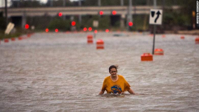 A woman who gave her name only as Valerie walks along flooded President Street after leaving her homeless camp in Savannah, Georgia, on Saturday, October 8. Hurricane Matthew has drenched Florida, Georgia and the Carolinas in recent days as it churned up the Atlantic Coast. As of Sunday morning, the storm had been downgraded to a cyclone and appeared to be heading out to sea.