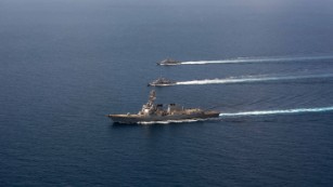 The USS Mason conducts formation exercises with Navy patrol crafts in September. 