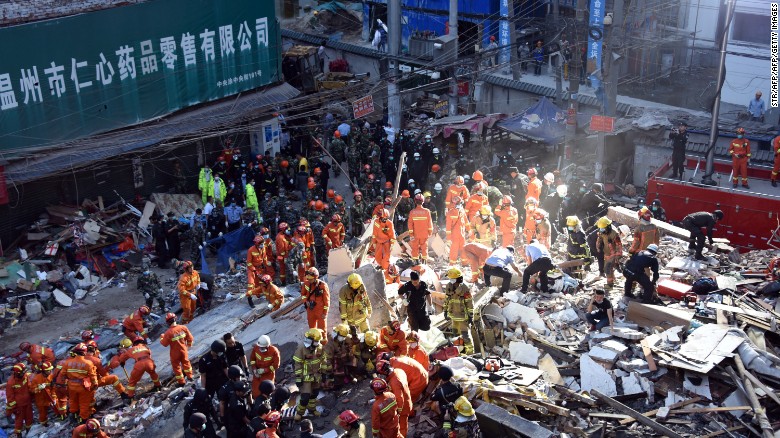 Rescuers search for survivors at an accident site after four buildings caved in during the early hours in Wenzhou, eastern China&#39;s Zhejiang province on October 10.