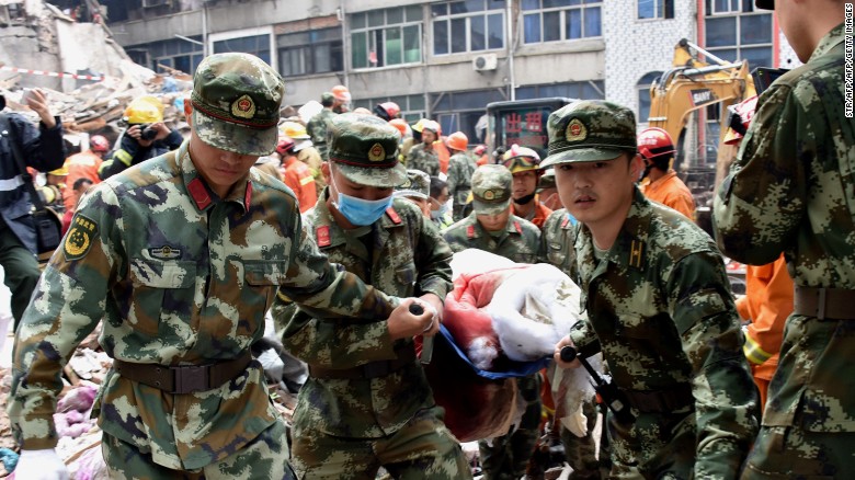 Rescuers carry an injured survivor on a stretcher at an accident site after  in Wenzhou, in China&#39;s Zhejiang province on October 10.