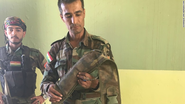 Captain Chilhan Sadk of the Peshmerga handles a diffused ISIS-made suicide belt.