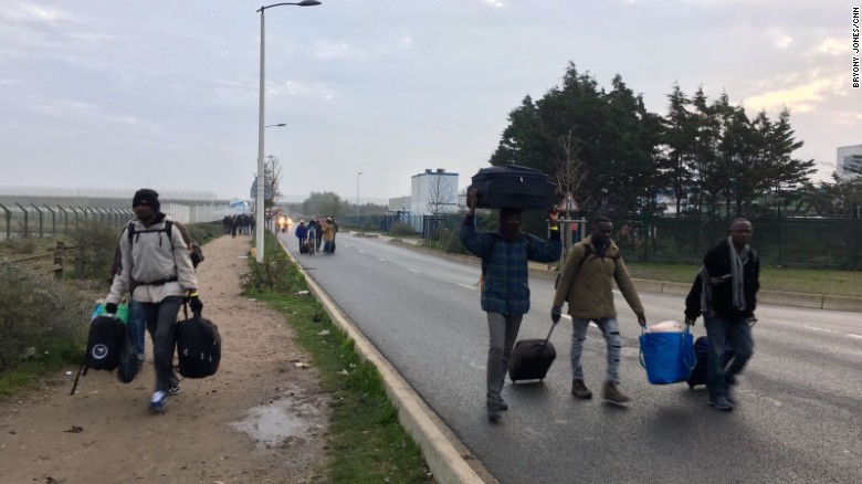 Migrants from &quot;The Jungle&quot; in Calais make their way to a processing center, where the will either claim asylum in France or choose to return to their home countries.