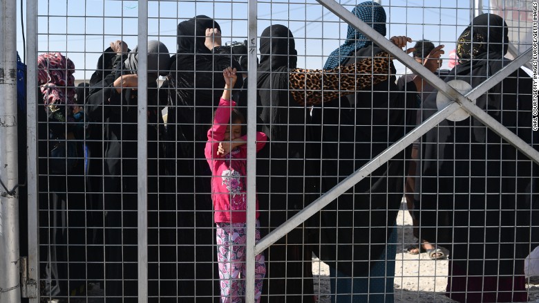 Iraqis displaced from Mosul line up for food and hygiene kits at a camp near near Qayyara.